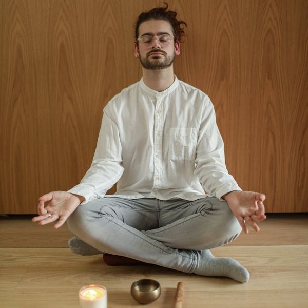Person meditating in a calm environment, symbolizing inner peace and well-being.